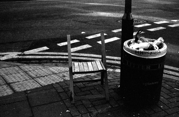 Street corner, chair and rubbish bin